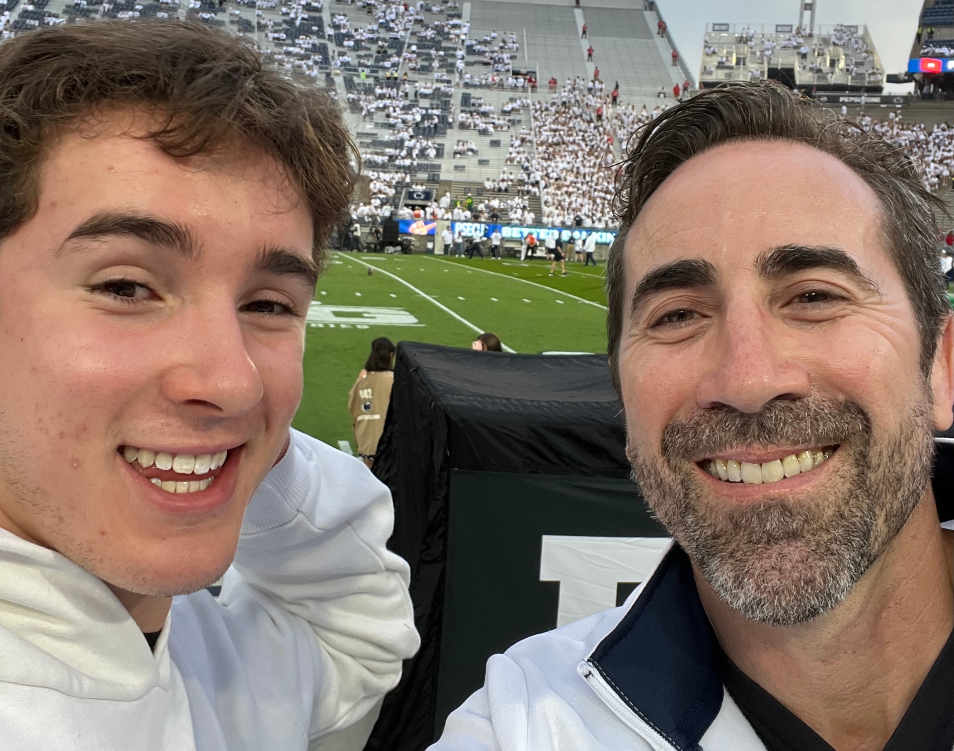 Mike and his son at a football game
